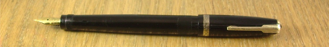 A small black pen with a gold (tone) point